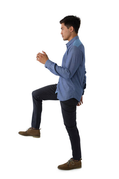 istock Side view of businessman standing on one leg 825715428