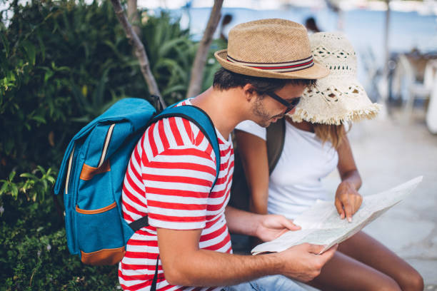 istock Tourists looking at city map 825715444