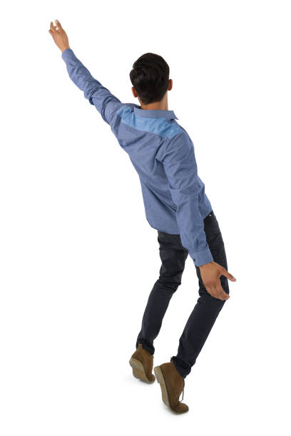 Rear view of businessman balancing Rear view of businessman balancing against white background falling behind stock pictures, royalty-free photos & images