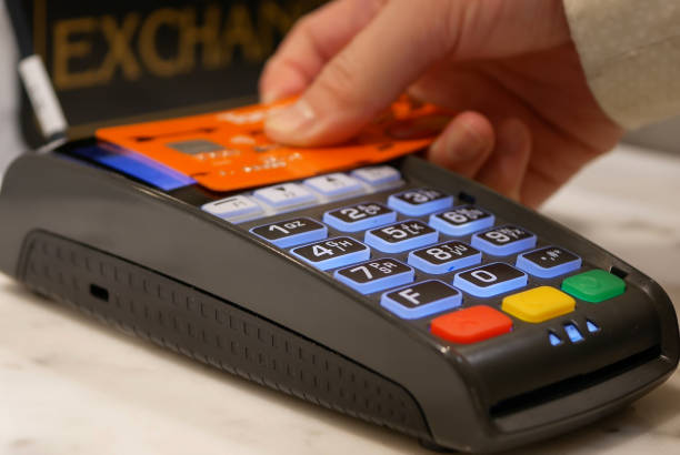 istock Woman tapping credit card on payment terminal 825718466