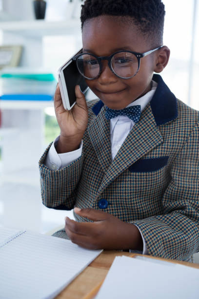 istock Businessman wearing eyeglasses using phone at desk 825721448