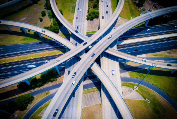 istock Dramatc Roads Curved highways and Interchanges and Overpasses aerial drone high above 825722604
