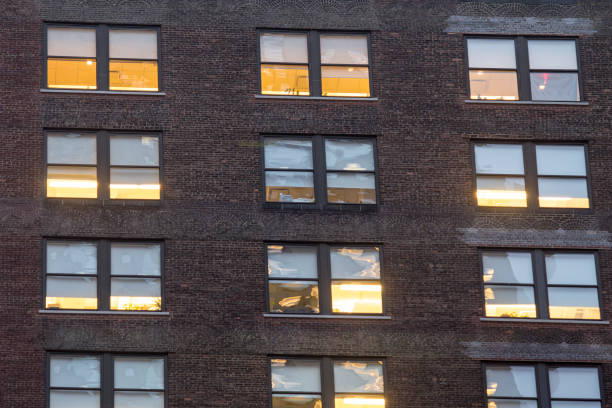 istock City apartment windows at night with lights for privacy concept. 825722644