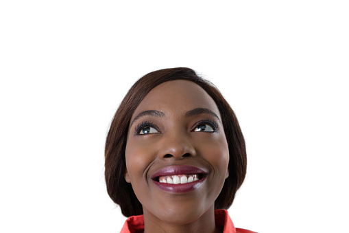Close up of cheerful woman looking up against white background