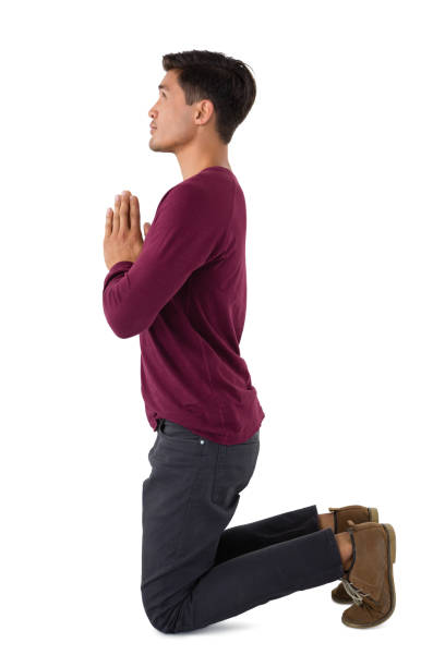 istock Side view of business praying 825734356
