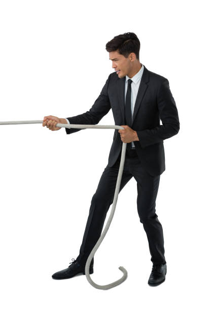 istock Full length of businessman pulling rope 825736552