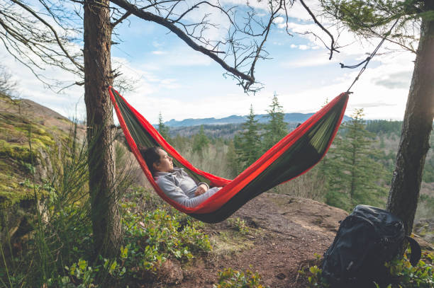 istock Young woman in hammock in forest 825737250
