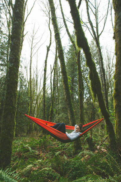 istock Young woman in hammock in forest 825737260