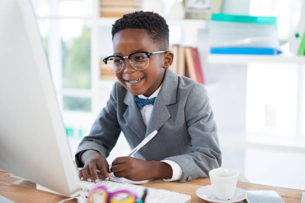 istock Smiling businessman writing report while looking at laptop 825737570