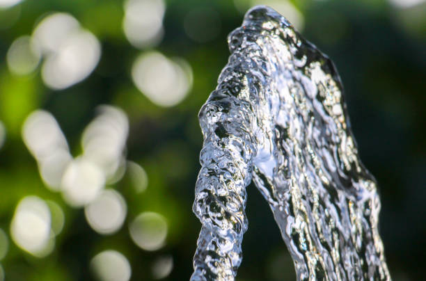 A fountain gurgles in a pond.