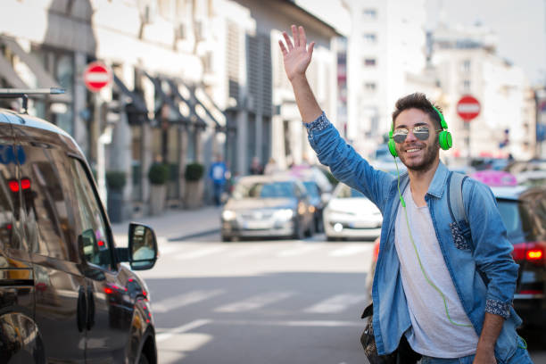 istock Young Man Hailing a Taxi . 825742976