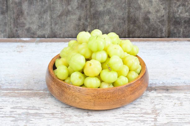 Star gooseberry fruit in wood bowl stock photo