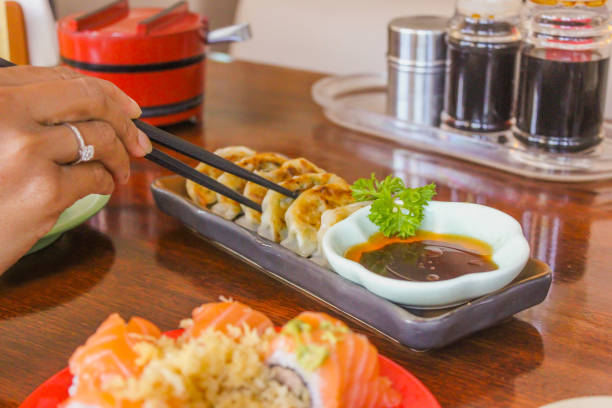 Women eating pan fried dumplings
