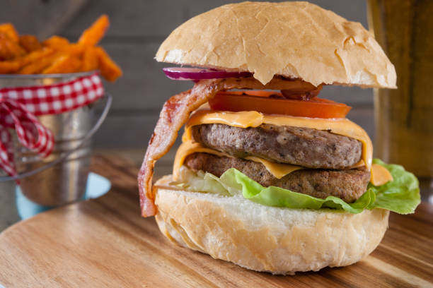 istock Hamburger and french fries on chopping board 825751416