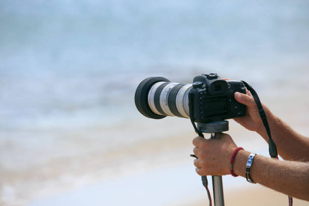 istock Photographer making a photo on the sea 825751432