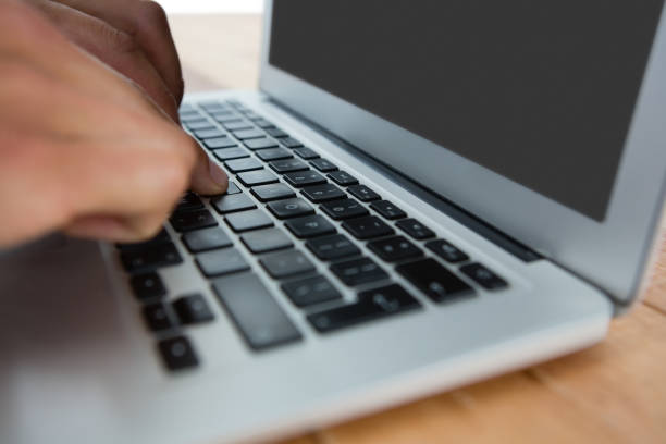 istock Cropped image of businessman using laptop 825754040
