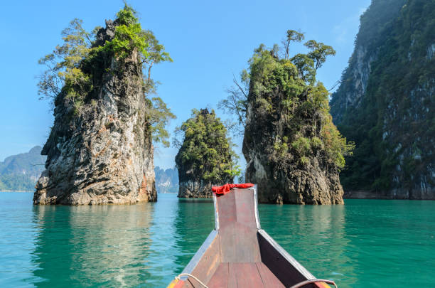 istock Limestone mountain ranges with long-tailed boat in Thailand 825754724