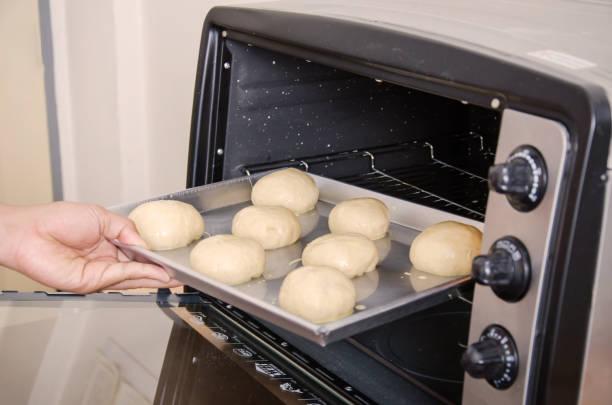 istock Bread dough on baking tray and bake in oven 825755100