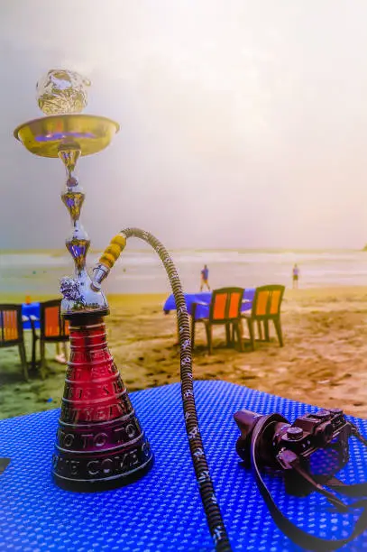 Photo of hookah shisha smoke on beach background