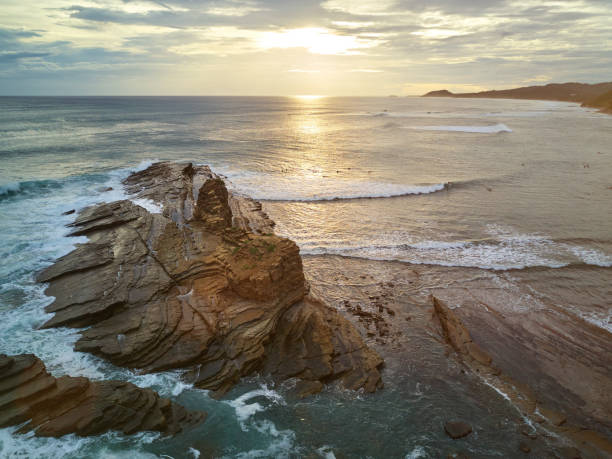 istock Surfers do it surf in sunset time 825755482