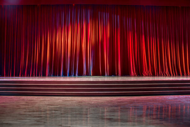 istock Red curtains and wooden stage. 825757924