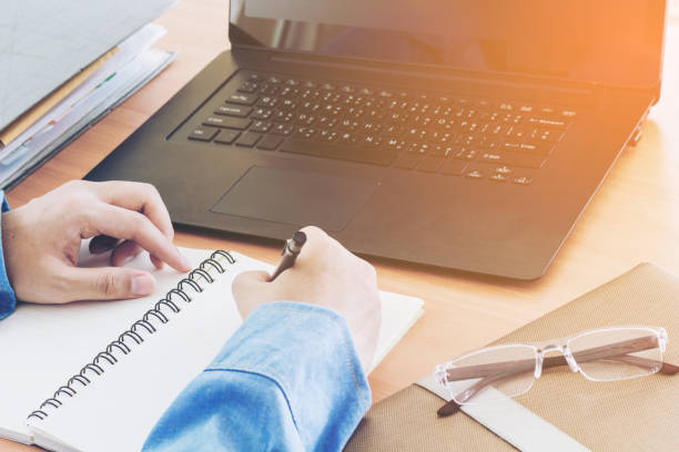 istock Businessman using  laptop at office desk 825761362