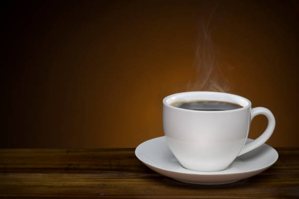 istock black coffee with smoke - hot coffee cup on wooden table with copy space good for text and graphic design 825766574