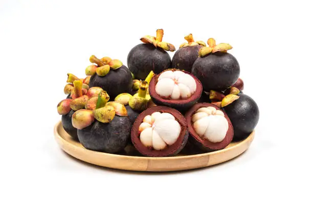Fresh Mangosteen from Rayong Thailand on wooden plate isolated on white background, Sweet delicious fruit