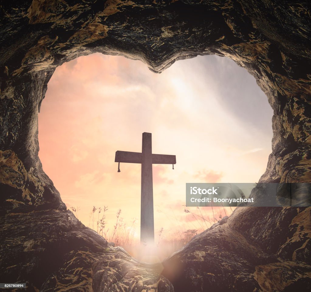 The cross Heart shape of tomb with the cross on meadow sunset background Jesus Christ Stock Photo