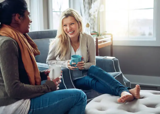 Shot of two young women having coffee together on a relaxing day at home