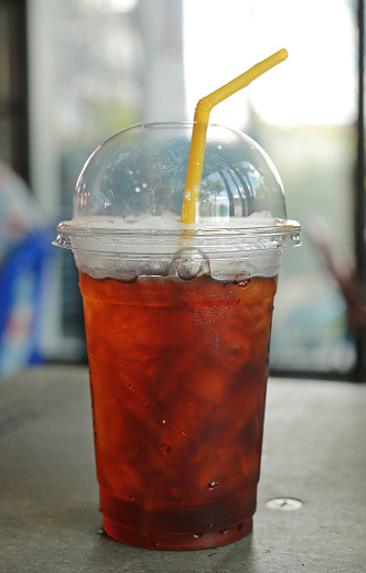 Plastic glass of cold iced black tea.