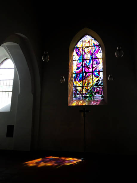 istock the god light from a Multicolored Glass in a church 825789662