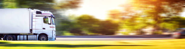 lorry moving on sunny evening asphalt roadwith a tilt truck. lorry moving on sunny evening road panoramic scenics journey stock pictures, royalty-free photos & images