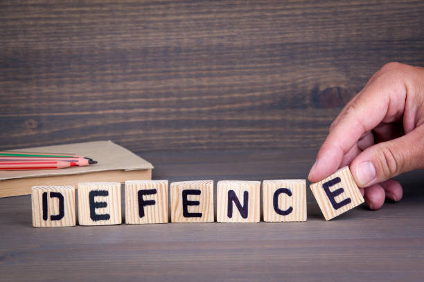 istock defence. Wooden letters on dark background 825794116