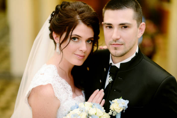 istock Wedding couple indoors is hugging each other 825802984