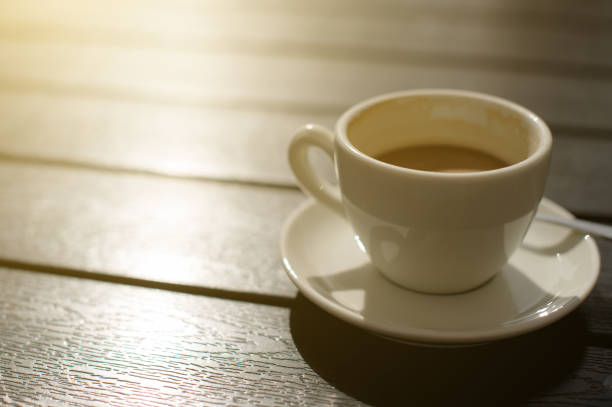 istock Cup of coffee on wooden table. 825803472