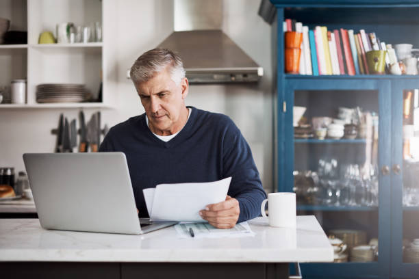 istock Keeping a close eye on his monthly finances 825810316