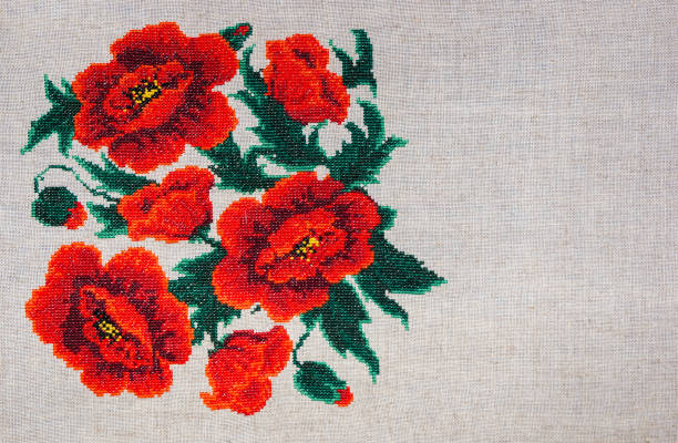 istock Red poppies embroidered on gray fabric. 825810930