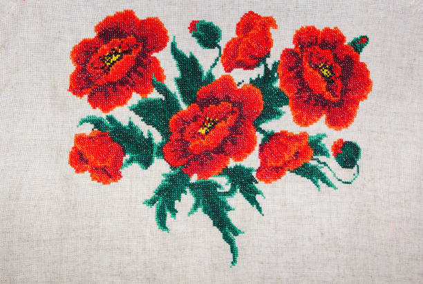 istock Red poppies embroidered on gray fabric. 825810932