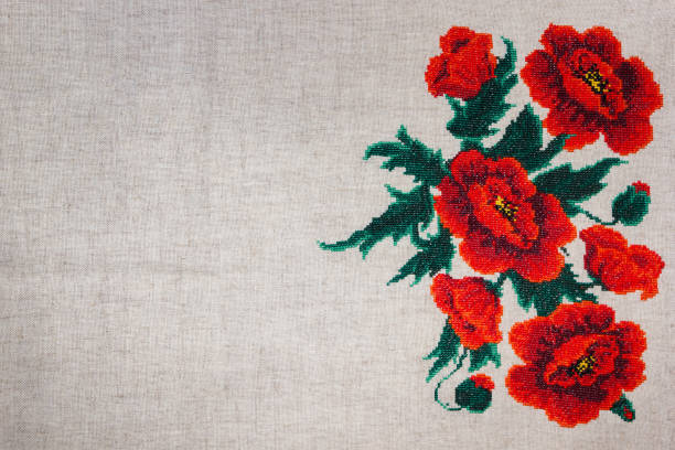 istock Red poppies embroidered on gray fabric. 825810942