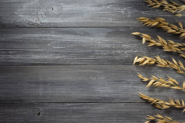 istock ears of oat on wood 825812364