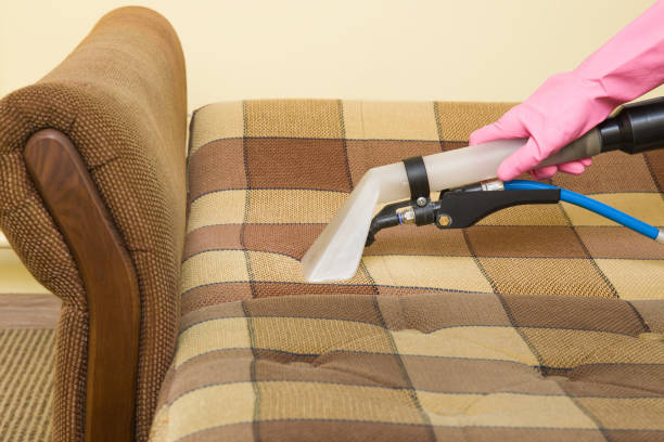 istock Sofa chemical cleaning with professionally extraction method. Hand in rubber protective glove holding nozzle of extractor. Upholstered furniture. Early spring or regular clean up. 825815634