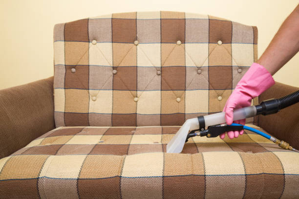istock Sofa chemical cleaning with professionally extraction method. Hand in rubber protective glove holding nozzle of extractor. Upholstered furniture. Early spring or regular clean up. 825818062
