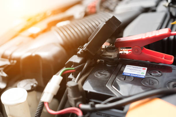 istock A car mechanic replaces a battery in selective focus. 825818094