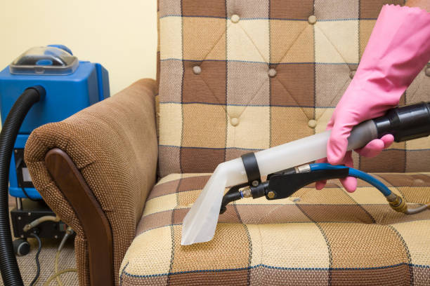 istock Sofa chemical cleaning with professionally extraction method. Hand in rubber protective glove holding nozzle of extractor. Upholstered furniture. Early spring or regular clean up. 825818352