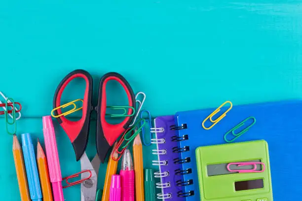 School supplies on blue background ready for design