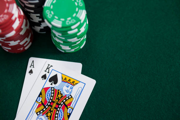 istock Playing cards and casino chips on poker table 825818590