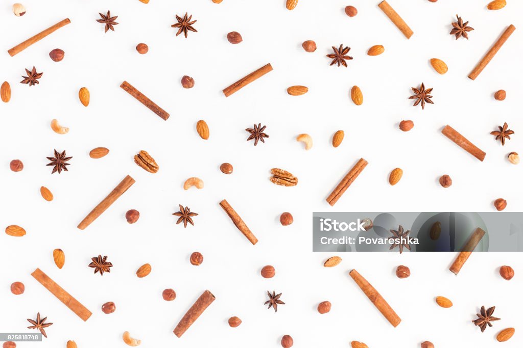 Pattern made of nuts, anise, cinnamon. Flat lay, top view Pattern made of nuts, anise star, cinnamon sticks. Flat lay, top view Spice Stock Photo