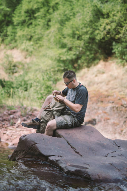 istock Hiker sitting next to the waterfall 825821744