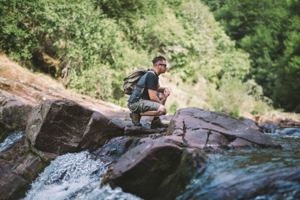 istock Hiker taking a rest at mountain creek 825821834